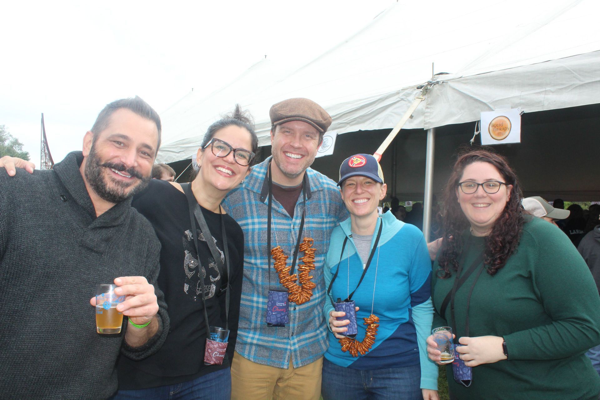 A group of people are posing for a picture in front of a tent.