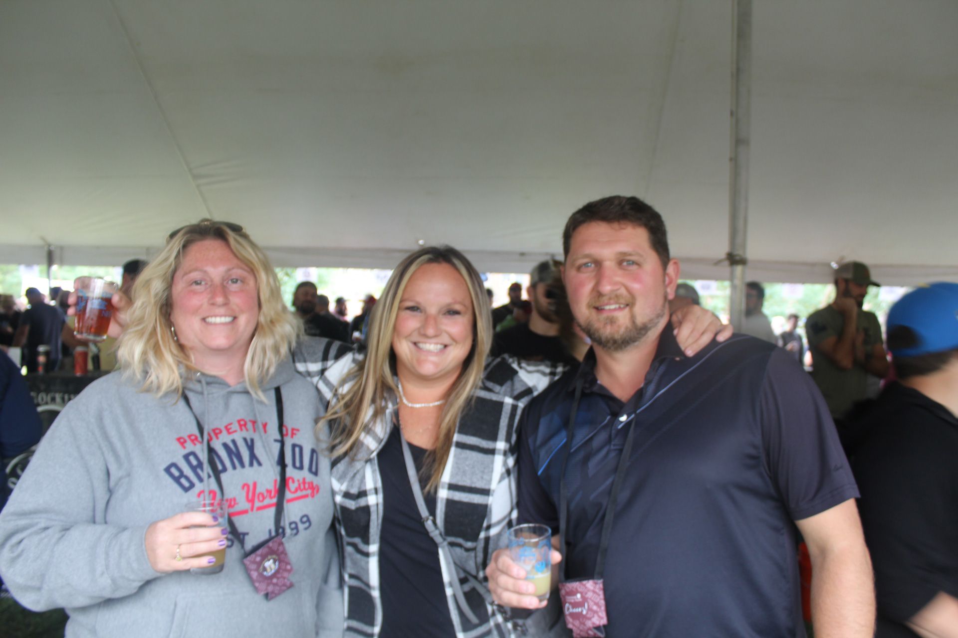 A group of people are posing for a picture under a tent.