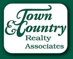 The logo for town & country realty associates is green and white.