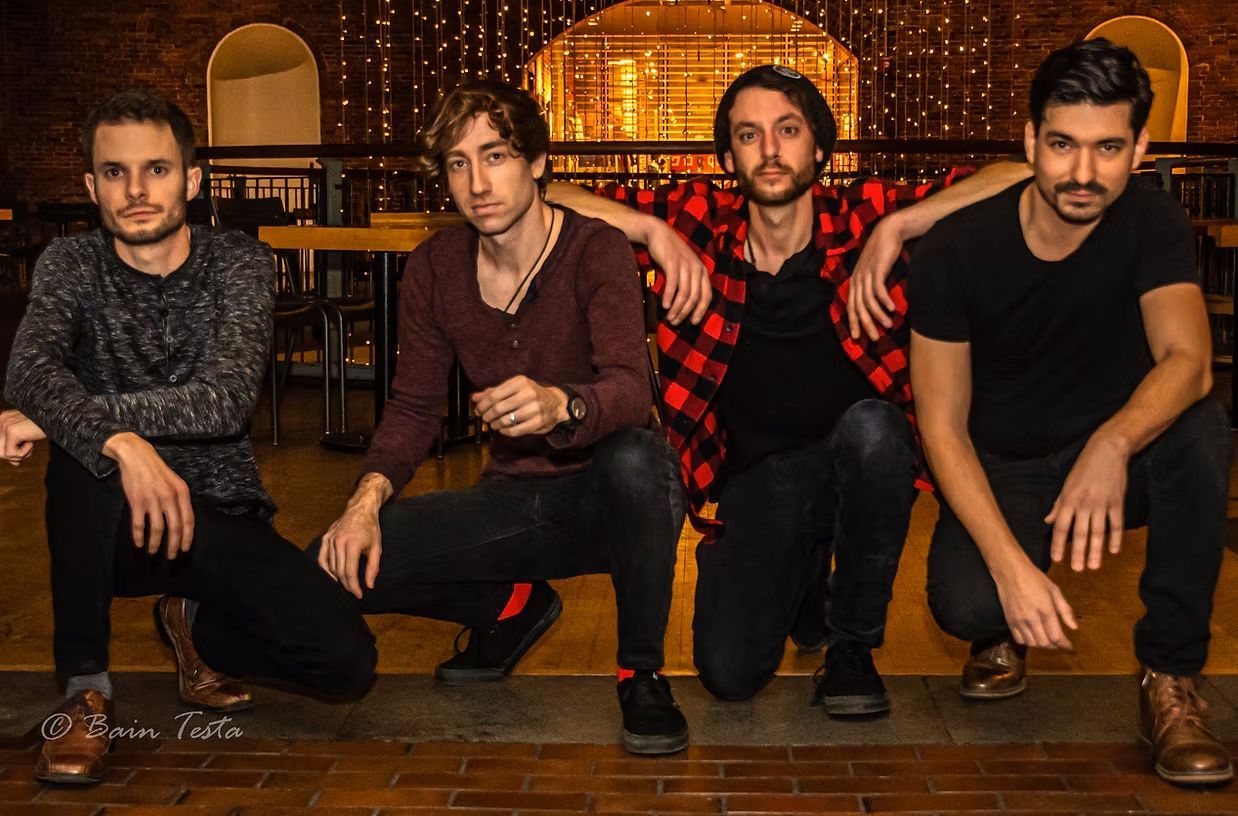 A group of men are posing for a picture in a room.
