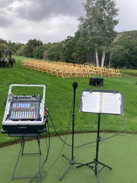 A microphone is sitting on a stand next to a music stand.