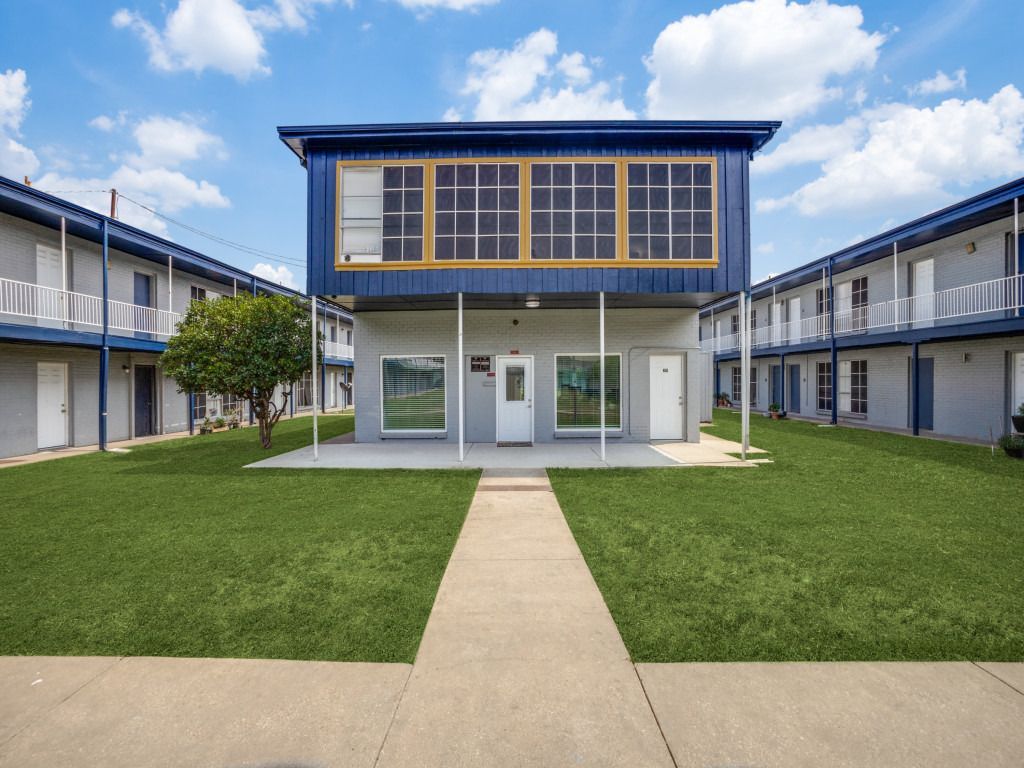 A building with a lot of windows and a walkway leading to it