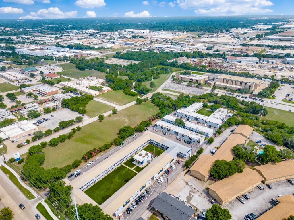 An aerial view of a city with lots of buildings and trees.