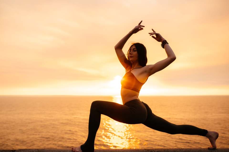 woman doing stretching on beach