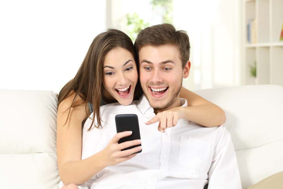 couple getting shocked while checking their mobile