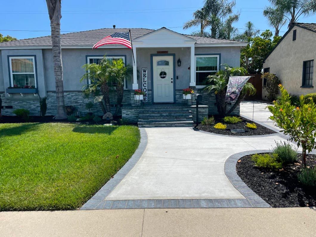 A house with a concrete driveway leading to it