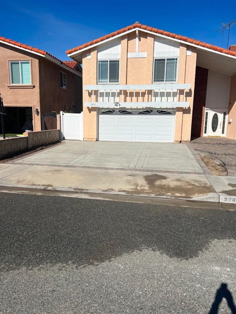 A house with a white garage door and a red roof
