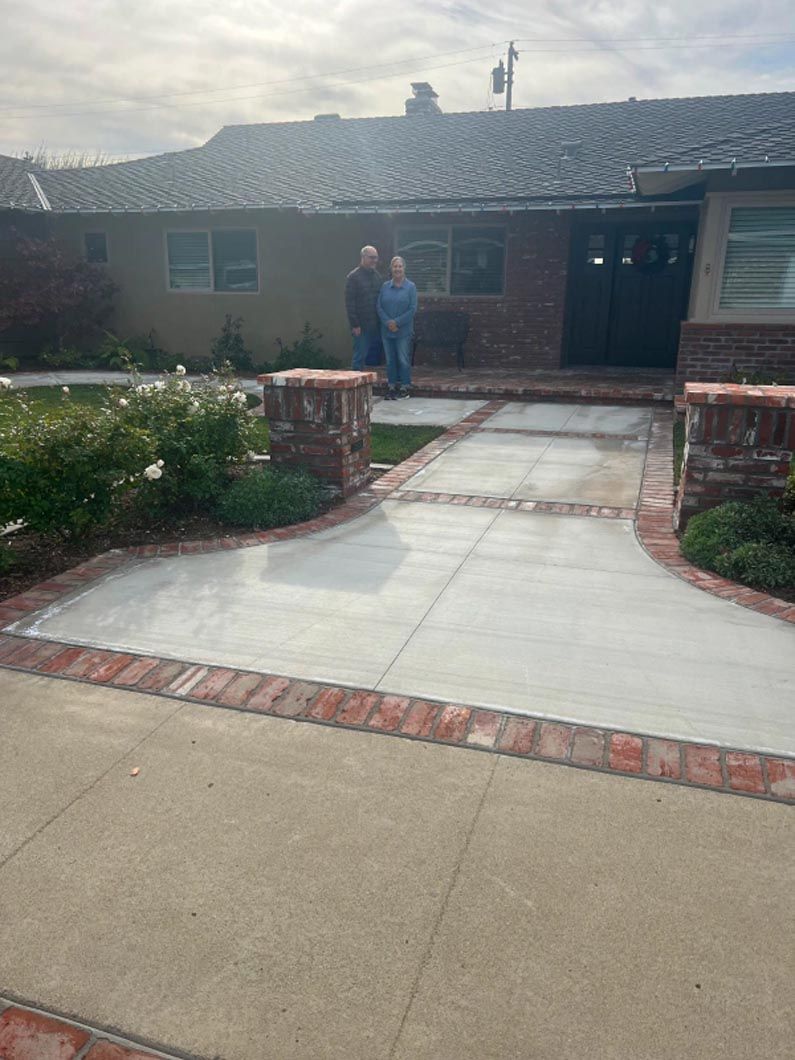 A couple of people are standing in front of a house.