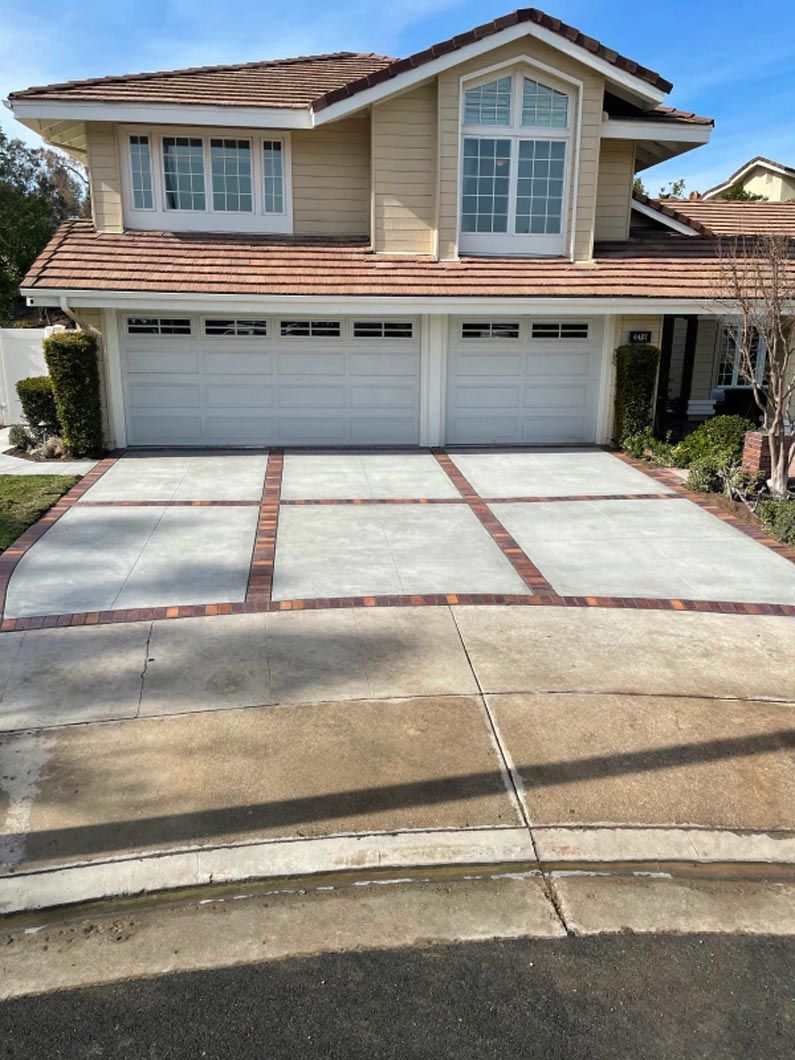 A large house with a concrete driveway in front of it