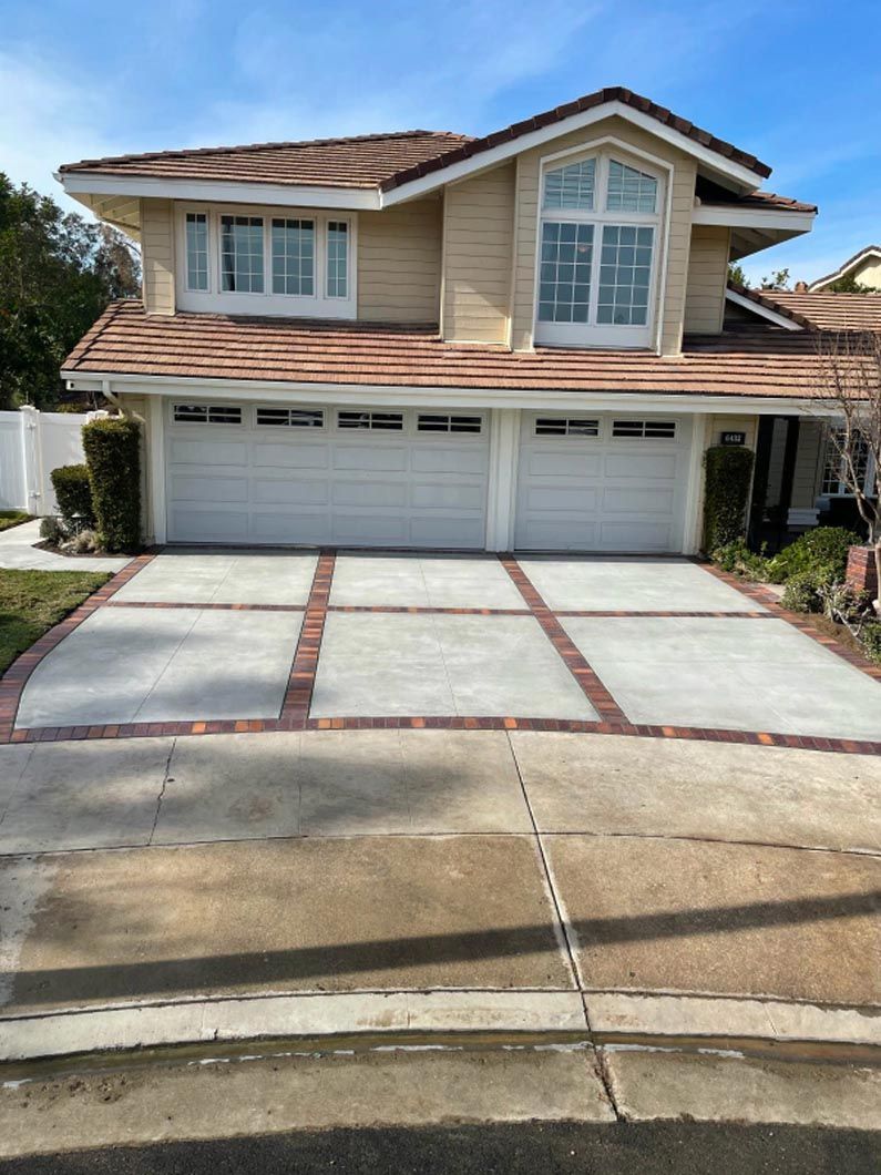 A large house with a concrete driveway in front of it.