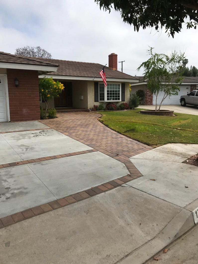 A house with a brick driveway leading to it
