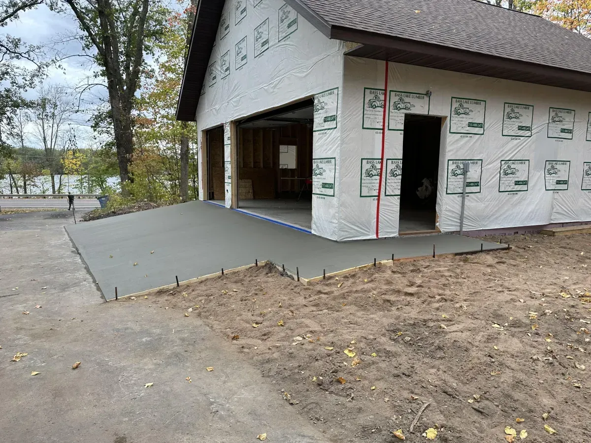 Partially built house with a wheelchair ramp leading to the open garage area