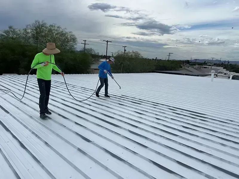 Steel roof with corrugated metal panels, supported by steel beams.