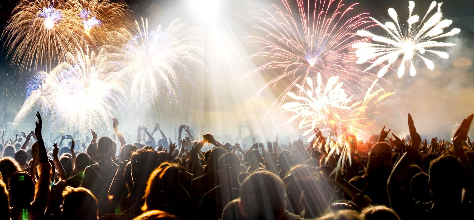 A crowd of people are watching fireworks in the sky.