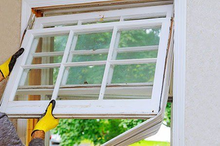 Man Replacing the Window — Green Bay, WI — Neville’s Inc.