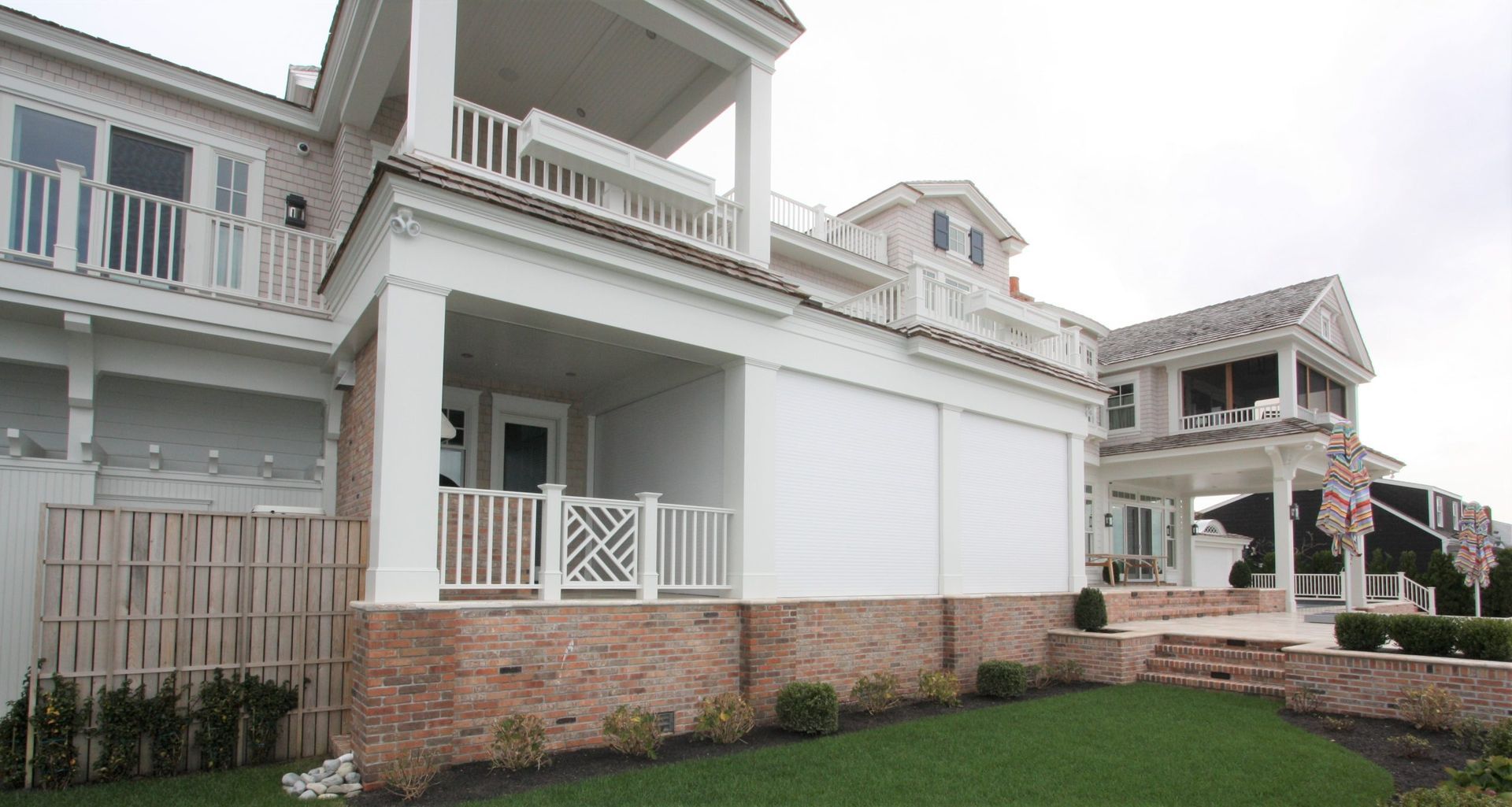 A large white house with a large porch and stairs