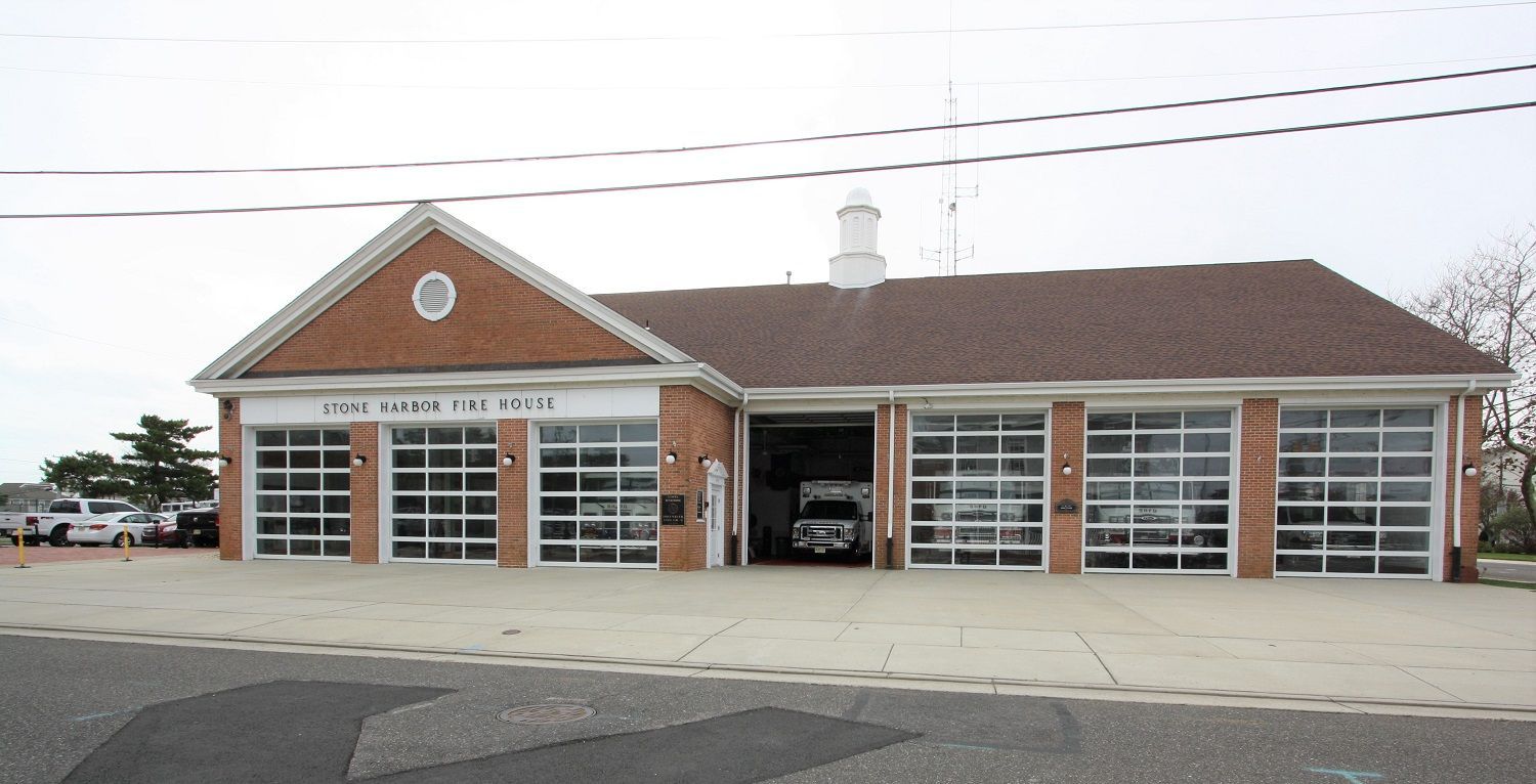 A brick building with a white sign that says fire station