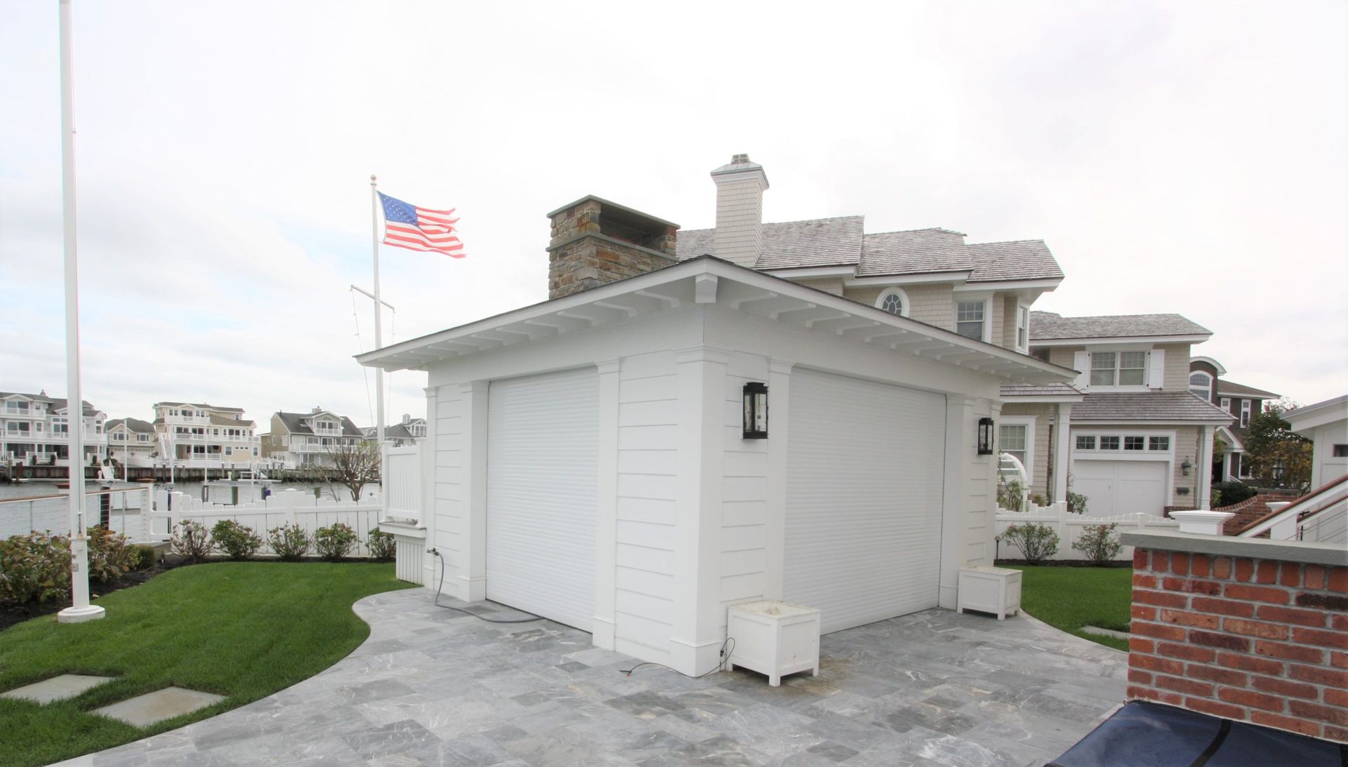 A white garage with an american flag on top of it
