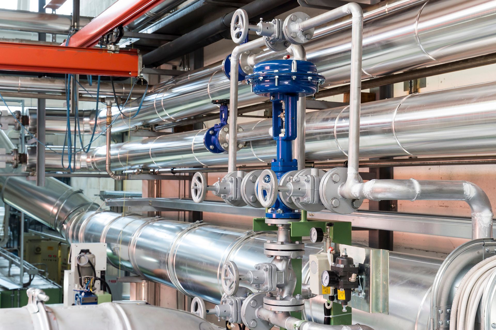 A bunch of pipes and valves in a factory.