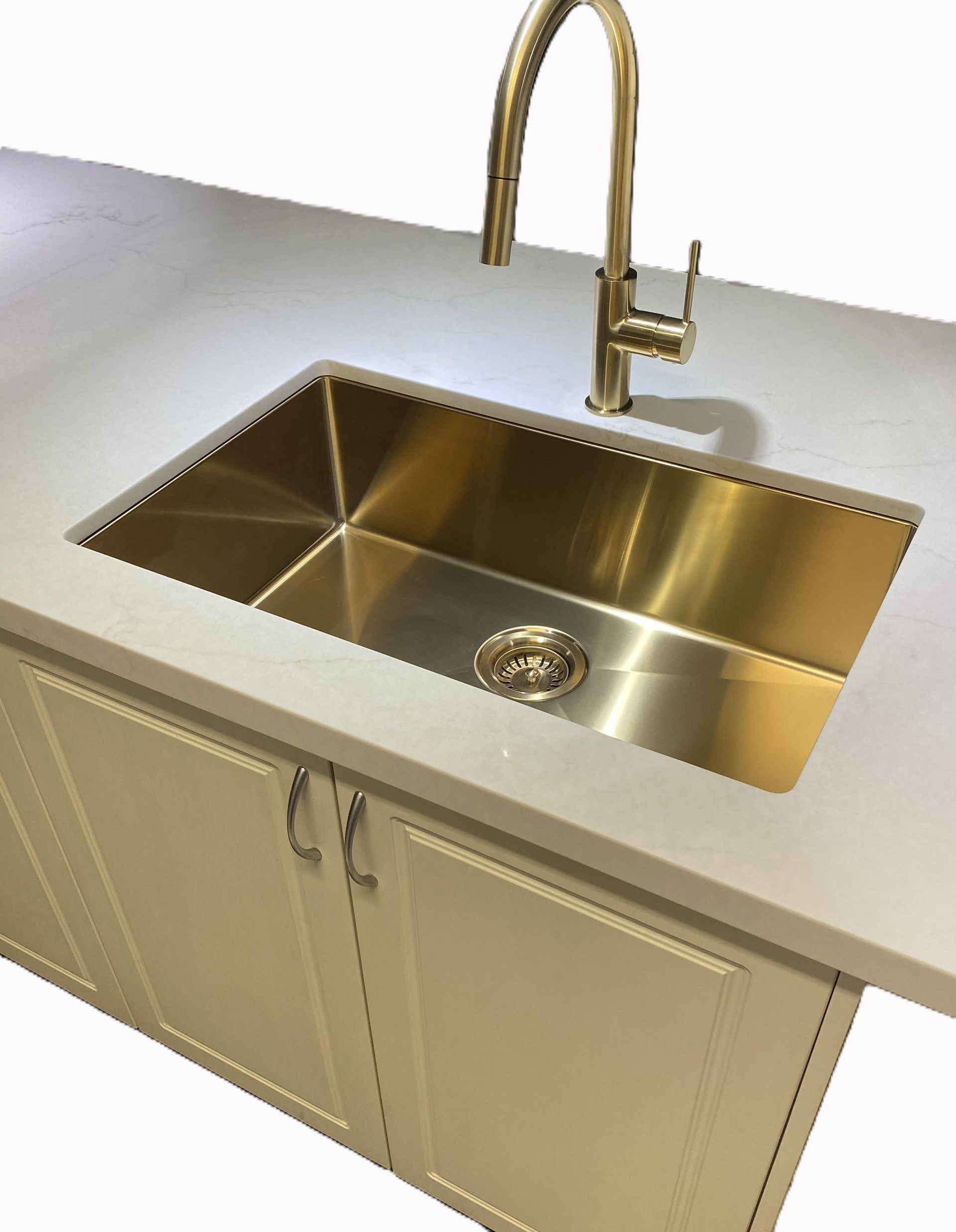 A stainless steel kitchen sink with a gold faucet