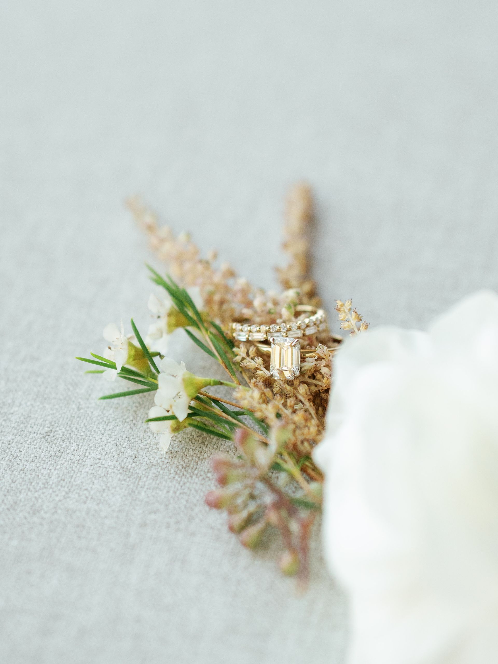 A close up of a wedding ring on a flower