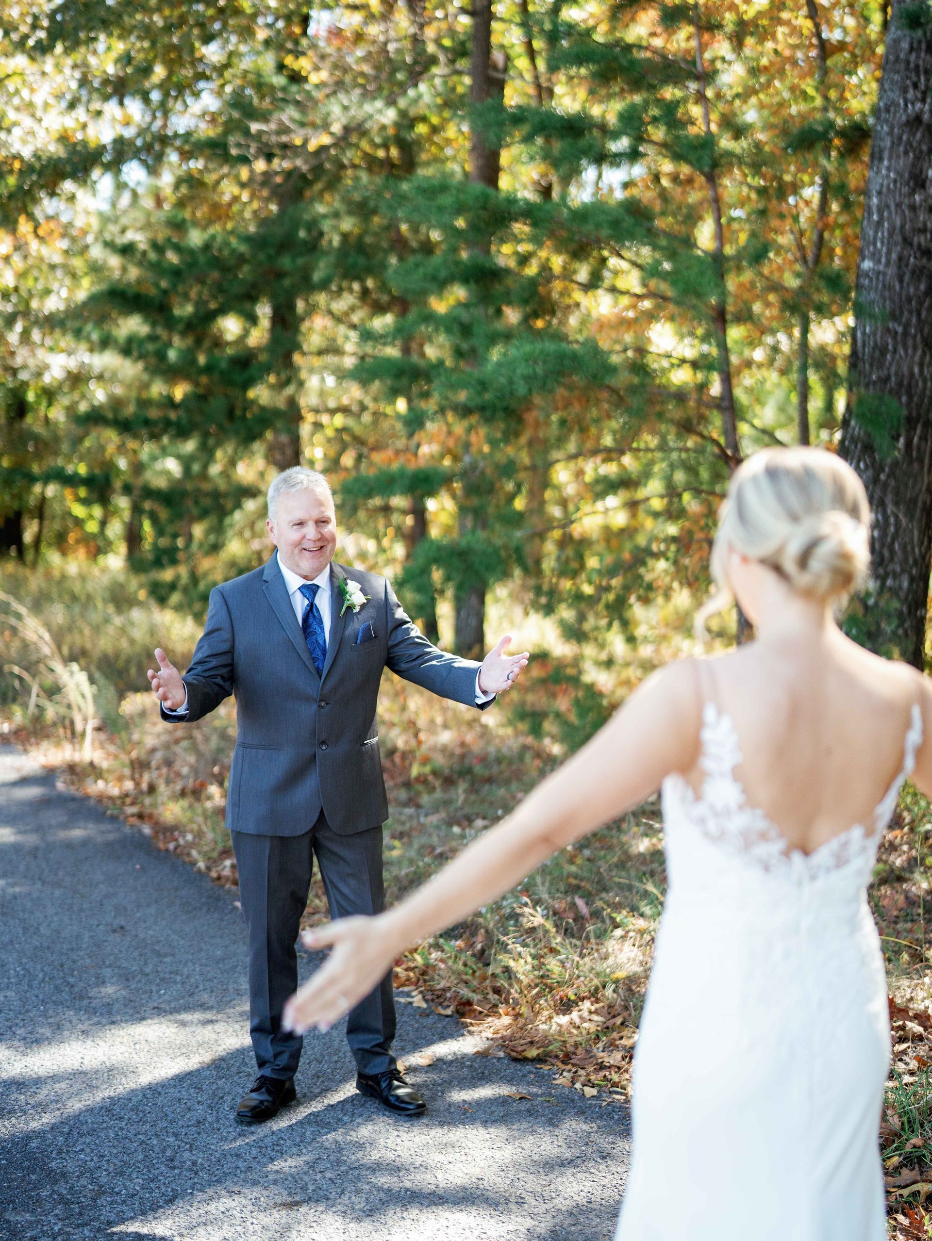A man in a suit and tie is standing next to a woman in a white dress