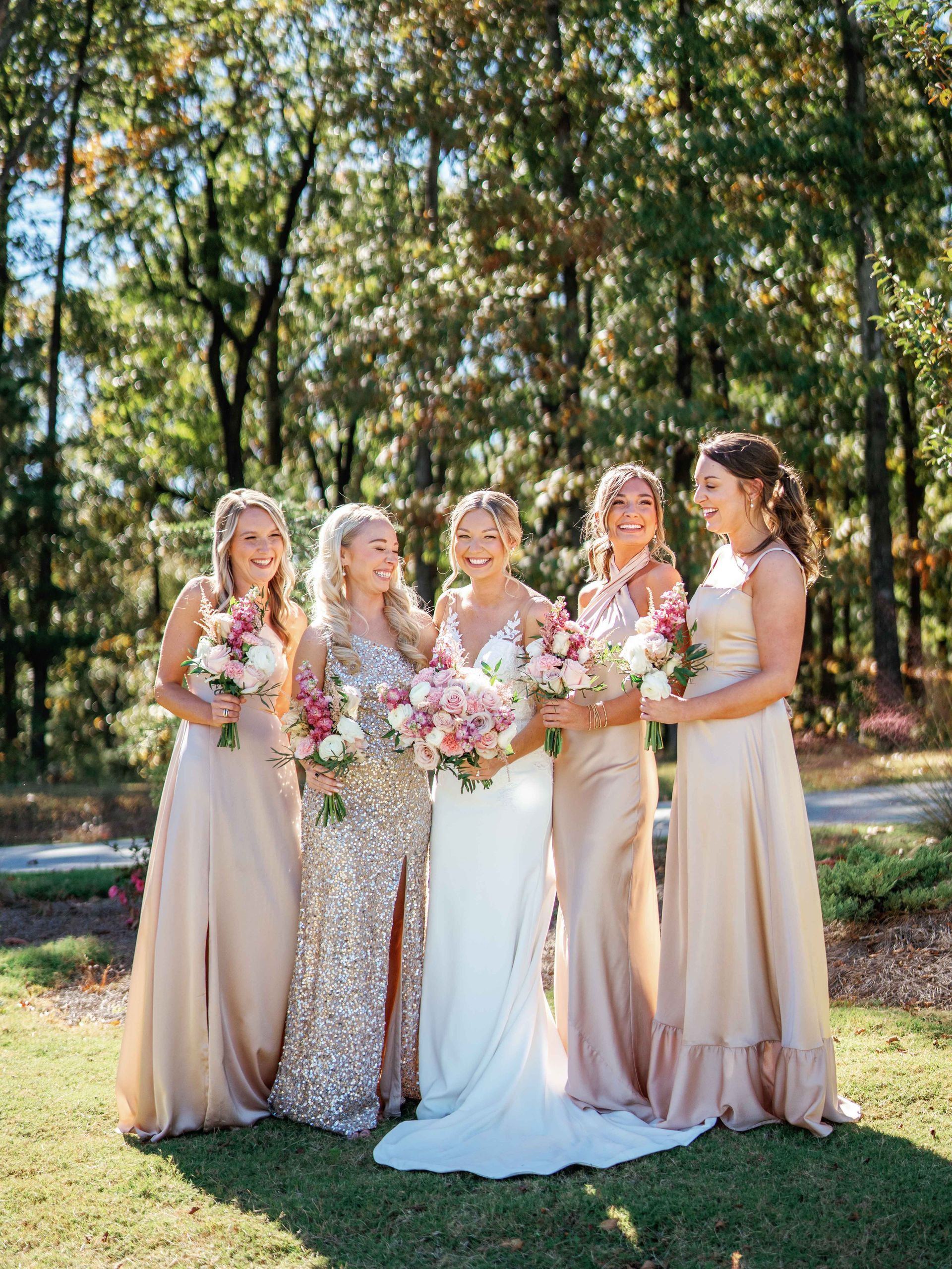 The bride and her bridesmaids are posing for a picture together