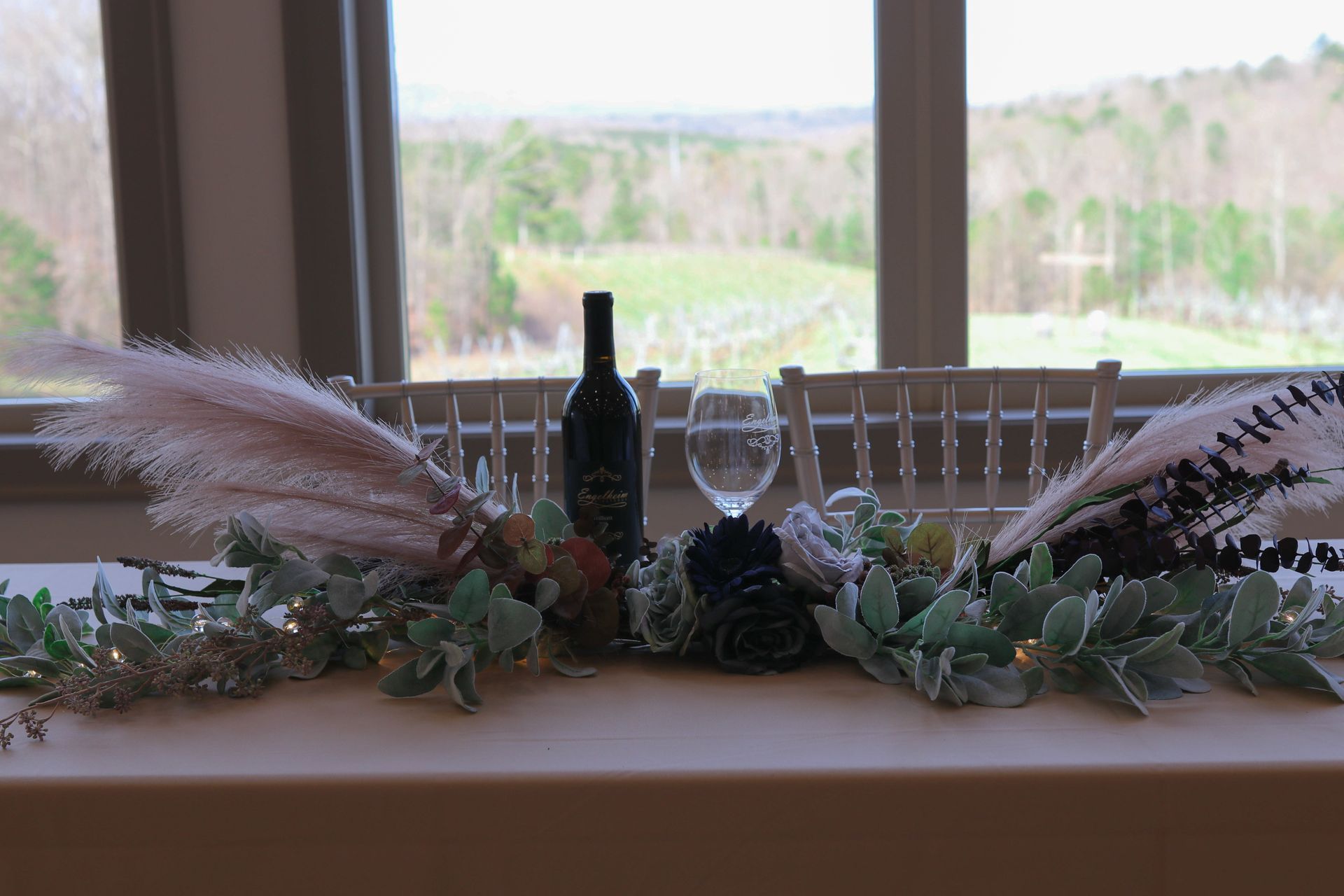 A table with a bottle of wine and glasses on it