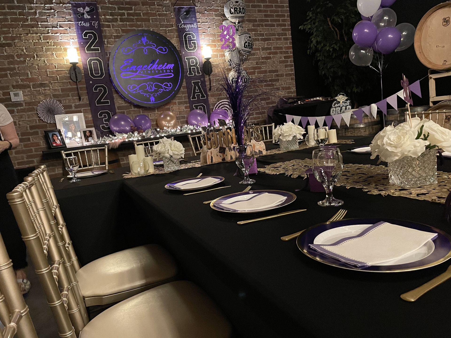A table set for a party with purple plates and silverware