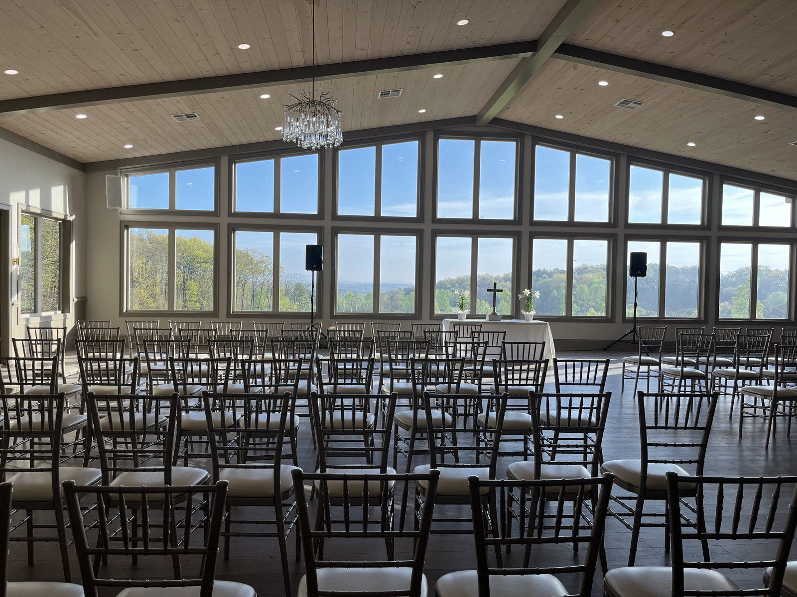 Rows of chairs in a large room with lots of windows