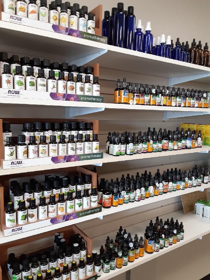A store shelf filled with lots of bottles of essential oils.