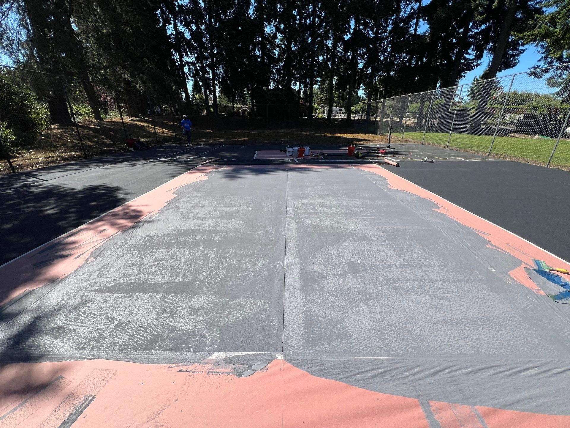 A man is standing on the side of a road.
