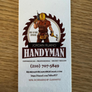 Handyman business card: Carpenter in front of a sawblade. Includes name, contact info, and guarantee.
