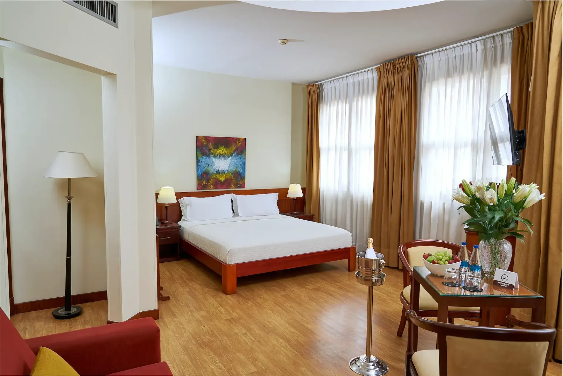 A hotel room with a large bed and a table