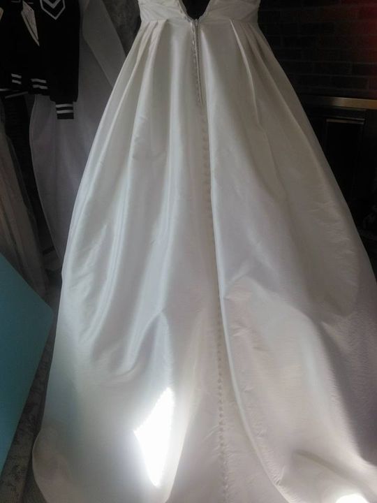 Professional checking wedding dress for alterations in Onalaska