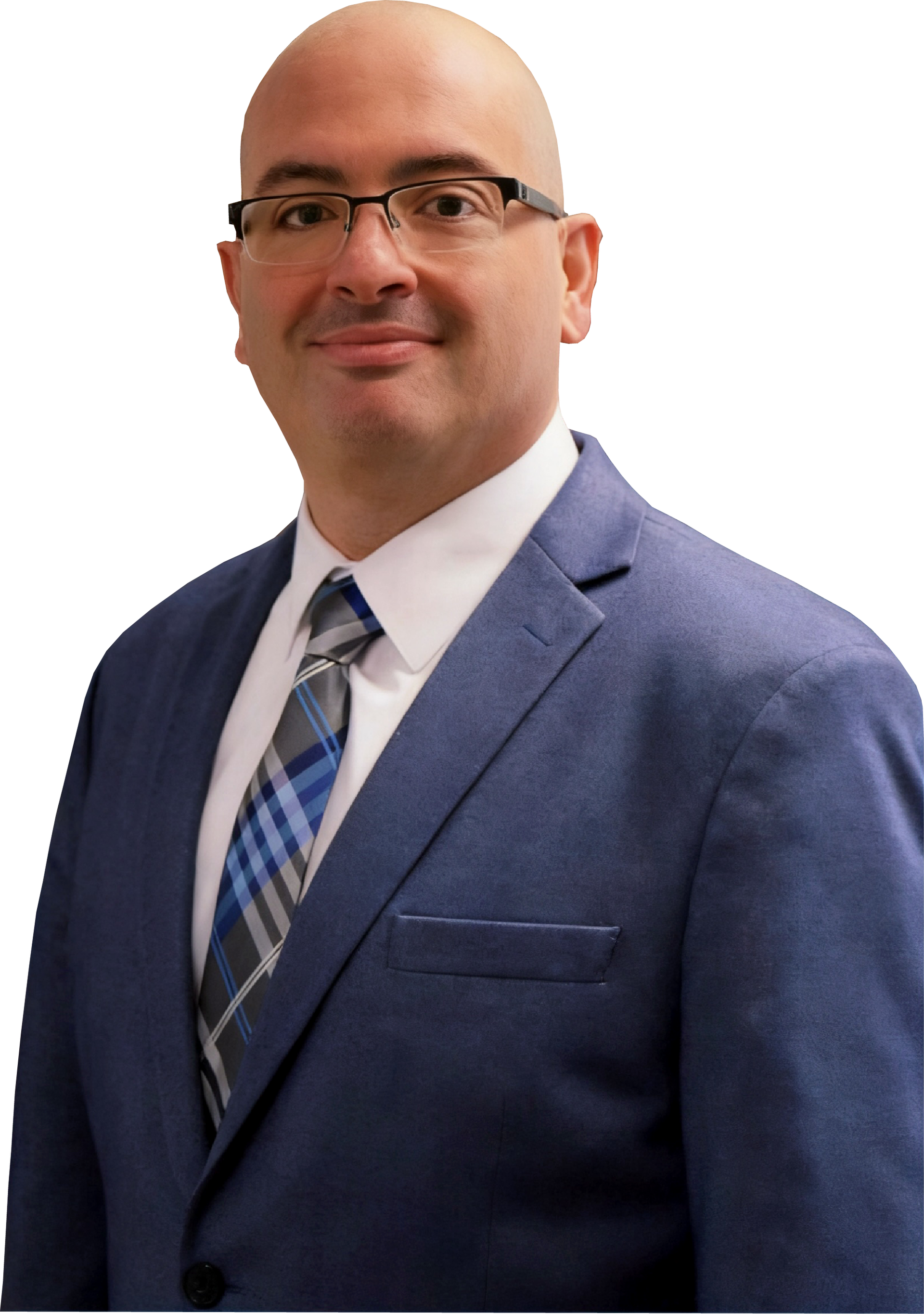 A person with a shaved head and glasses, wearing a blue blazer, white shirt, and plaid tie against a white background.