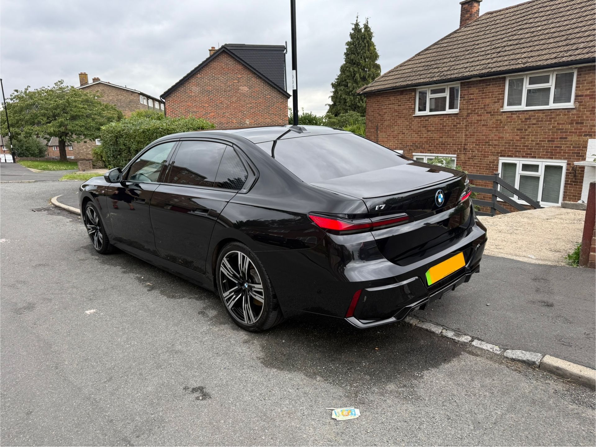 Black BMW sedan parked on a residential street.