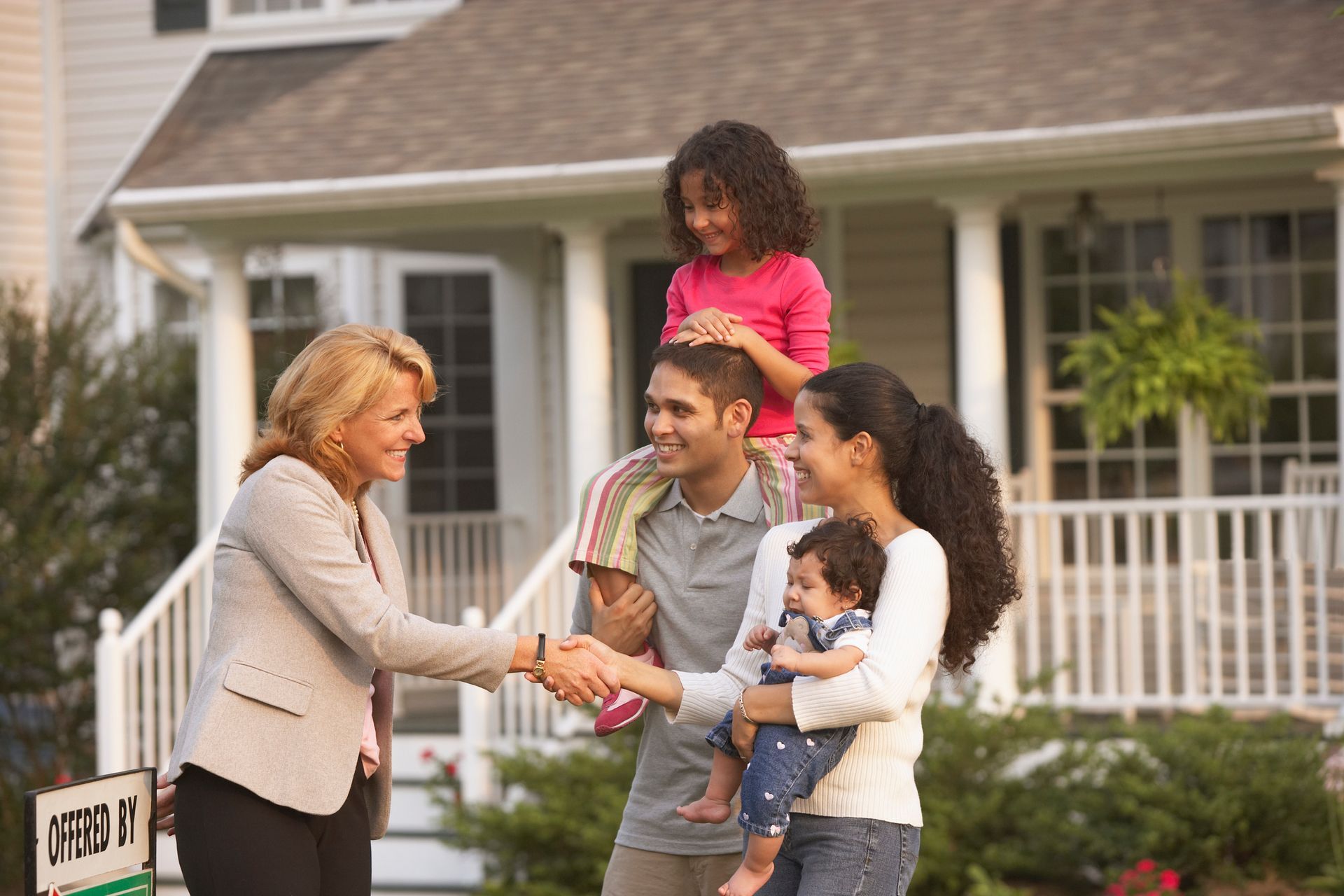 Hispanic Family Shaking Hands With Real Estate Agent — Casper, WY — Commercial Services Inc.