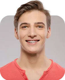 A young man wearing braces is smiling for the camera.