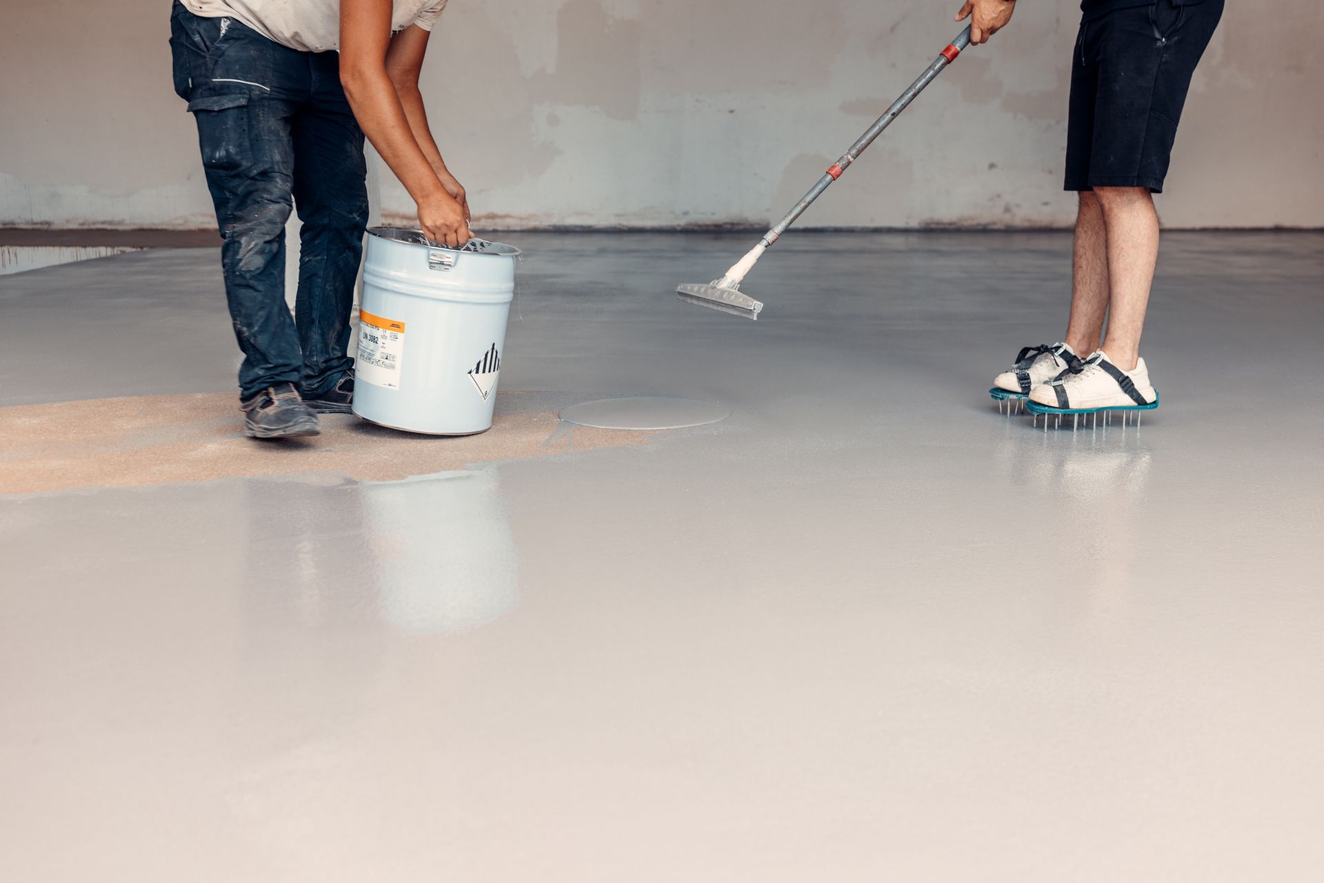 Workers Applying Gray Epoxy Resin — Woodstock, GA – Creative Spaces, LLC