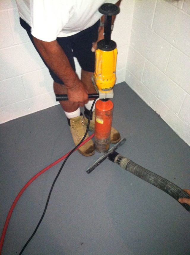 A Man is Using a Drill - Youngstown, OH - Radon Raiders