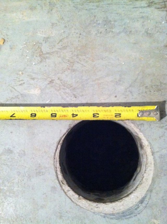 A Tape Measure is Measuring a Hole - Youngstown, OH - Radon Raiders