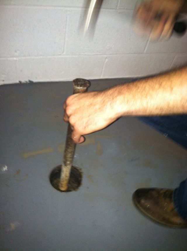 A Man is Using a Hammer - Youngstown, OH - Radon Raiders