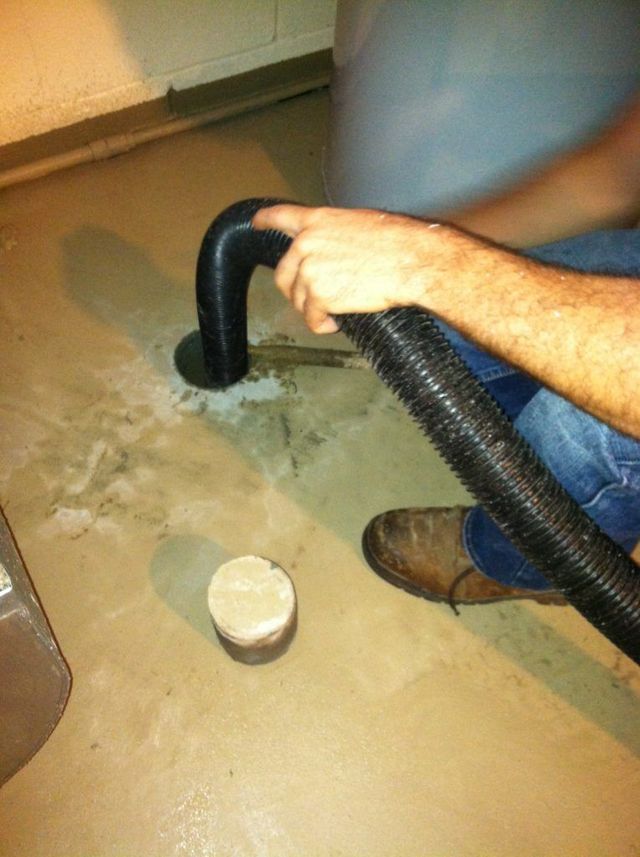 A Person is Using a Vacuum to Clean the Hole - Youngstown, OH - Radon Raiders