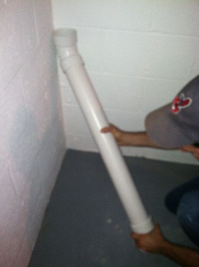 A Person is Holding a Long White Pipe - Youngstown, OH - Radon Raiders