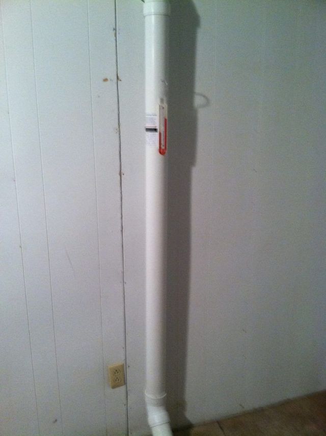 A White Pipe is Hanging From a White Wall in a Room - Youngstown, OH - Radon Raiders