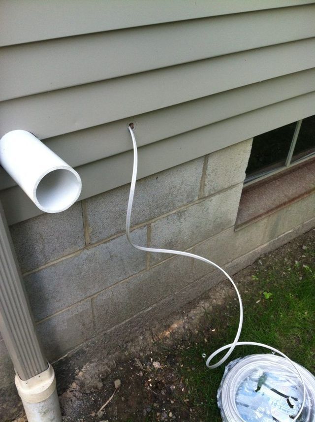 Installing White Pipe to the Siding of a House - Youngstown, OH - Radon Raiders