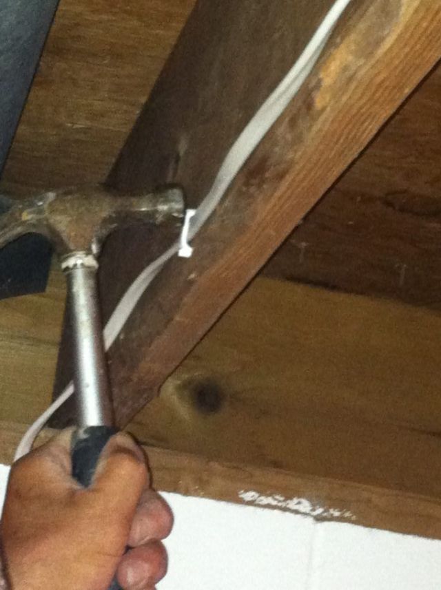 A Person is Hammering a Nail Into a Wooden Beam - Youngstown, OH - Radon Raiders