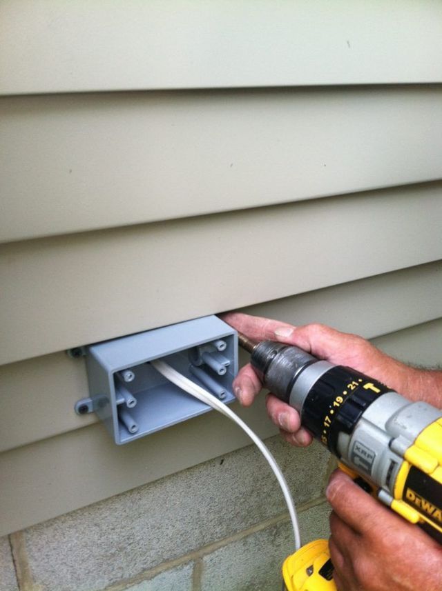 A Person is Using a Drill to Install a Junction Box - Youngstown, OH - Radon Raiders