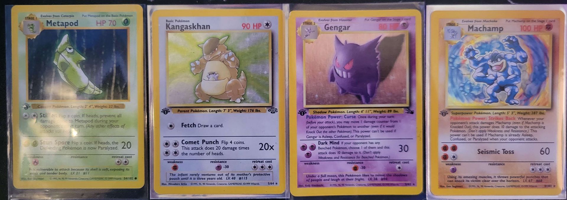 first edition Pokémon cards sitting next to each other